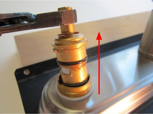 Hold the stem of the cartridge and pull up until the cartridge is completely removed from the faucet body