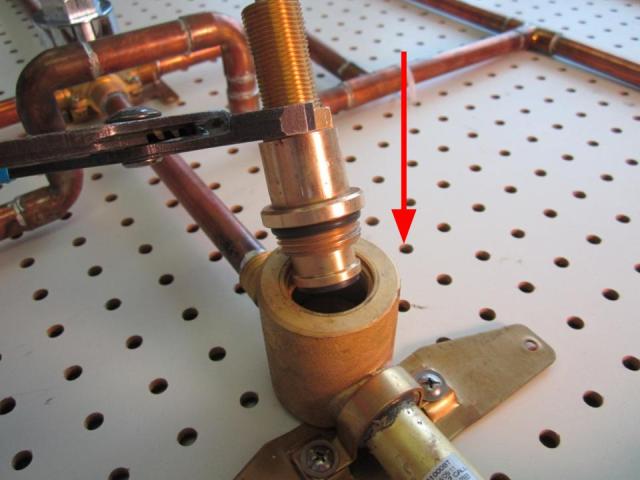 Insert the new cartridge into the faucet body and screw it into the faucet body by turning clockwise. In order to avoid over tightening the locking nut, hand tighten the locking nut, and then use the adjustable pliers to apply a quarter turn. Approximately 10-14 lbs of torque are required to properly install the locking nut.