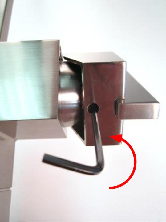 Insert the hex wrench into the opening so that it engages the screw. Turn counter-clockwise a quarter turn to loosen the set screw.