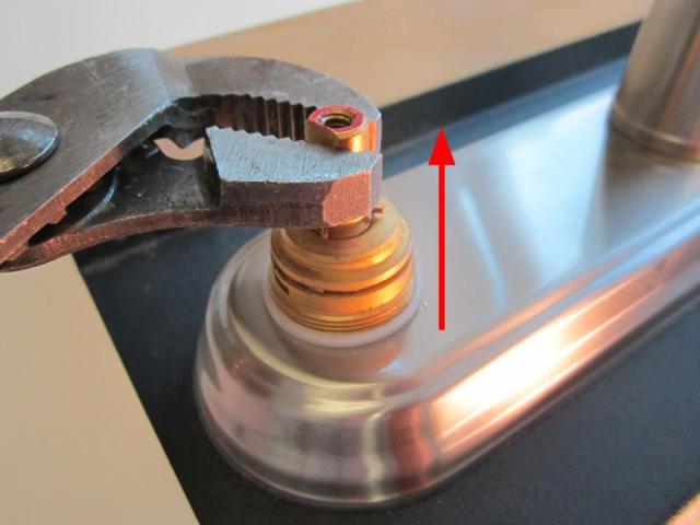 Hold the stem of the cartridge and pull up until the cartridge is completely removed from the faucet body