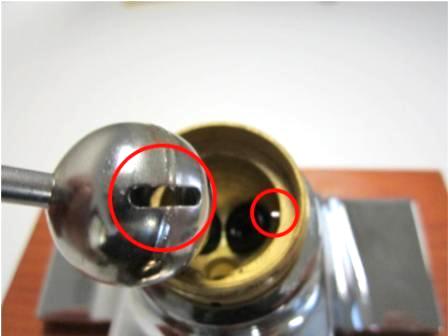 Insert the ball valve into the faucet body. To do so, locate the locator pin in the faucet body, and locate the straight, narrow opening on the ball valve. 