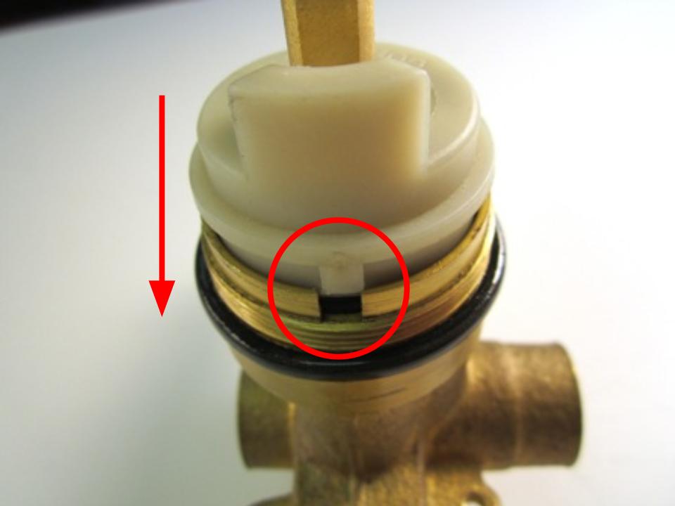Slide the cartridge in so that the notches on the cartridge line up with the opening in the faucet body.