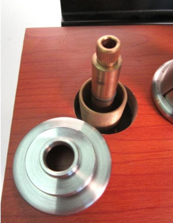 The faucet body is visible, once the trim ring has been removed.