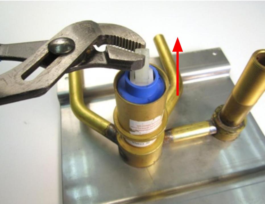 Hold the stem of the cartridge and pull up until the cartridge is completely removed from the faucet body