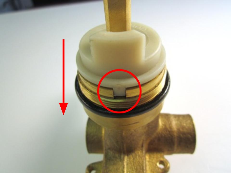 Slide the cartridge in so that the notches on the cartridge line up with the opening in the faucet body.