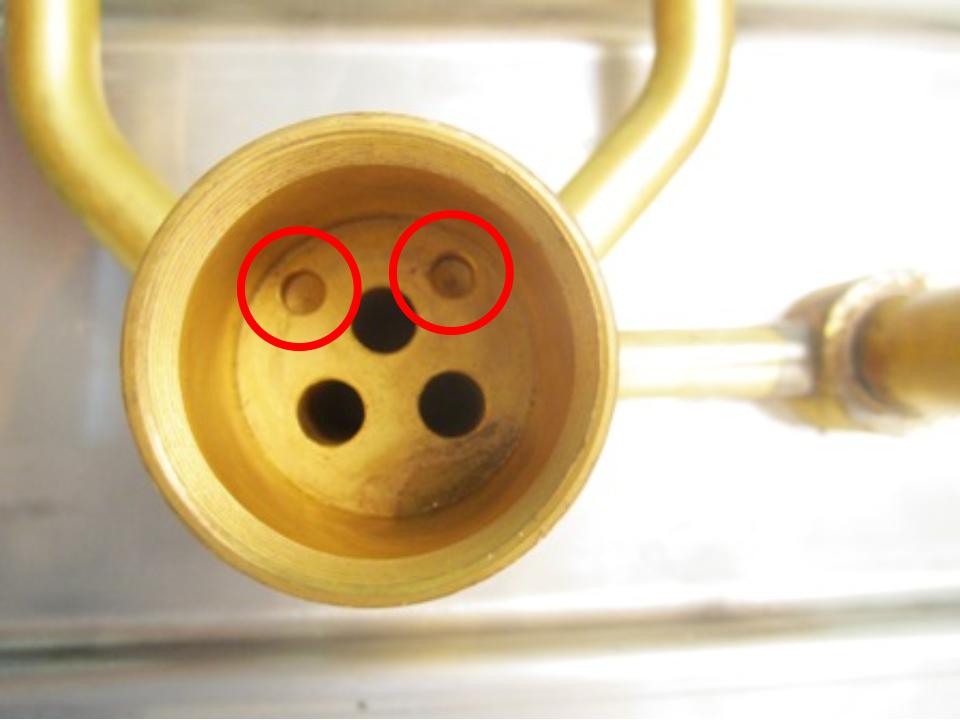 Locate the locating pins on the bottom of the cartridge and locate the corresponding holes in the faucet body. 