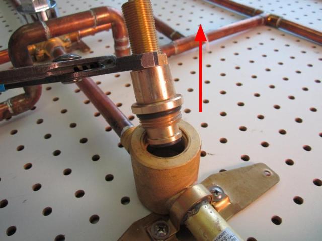  Using a pair of adjustable pliers, unscrew the cartridge counter-clockwise until the cartridge is completely removed from the faucet body.