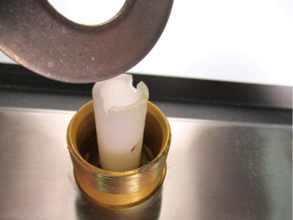  Once the spout has been removed, the top of the diverter should be visible. Locate the two openings and insert a flat tool or object. Turn counter-clockwise until it is completely removed from the faucet body.