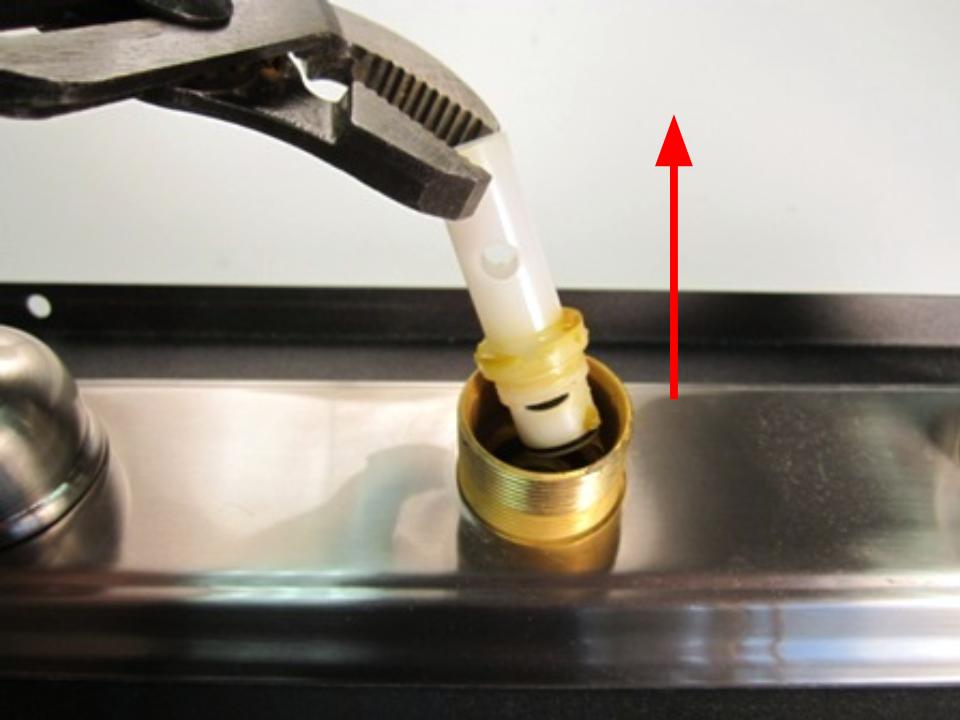 Once the spout has been removed, the top of the diverter should be visible. Locate the two openings and insert a flat tool or object. Turn counter clockwise until it is completely removed from the faucet body.