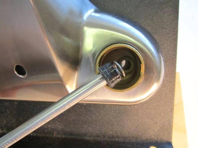 If you cannot remove the seat and spring with your fingers, use a pair of needle nose pliers or a straightened paper clip to remove them.