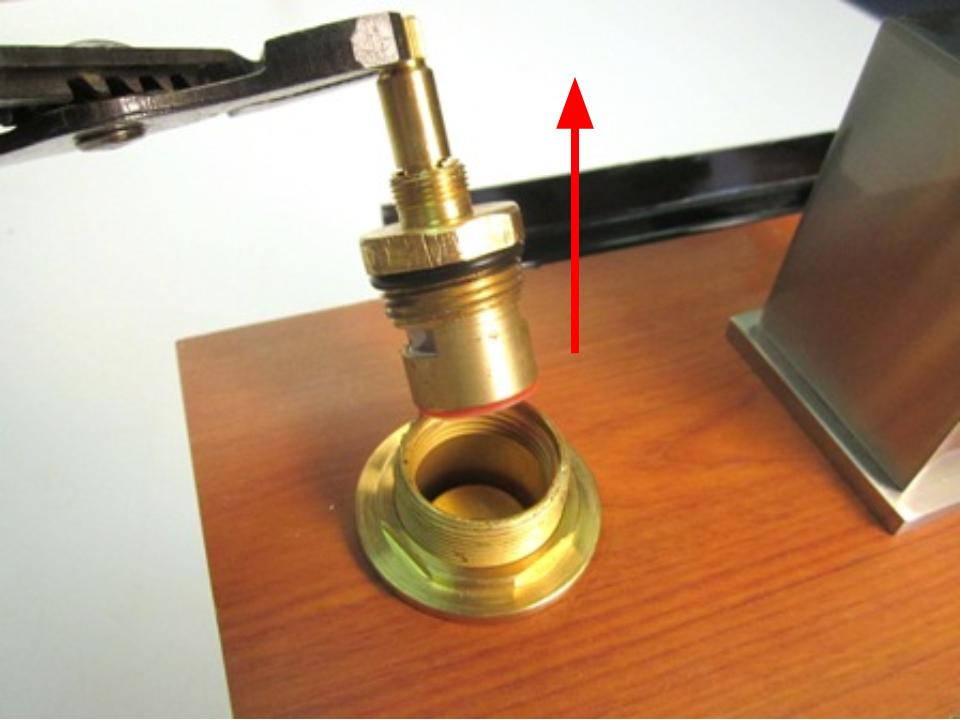 Holding the stem of the cartridge, pull up until the cartridge is completely removed from the faucet body.