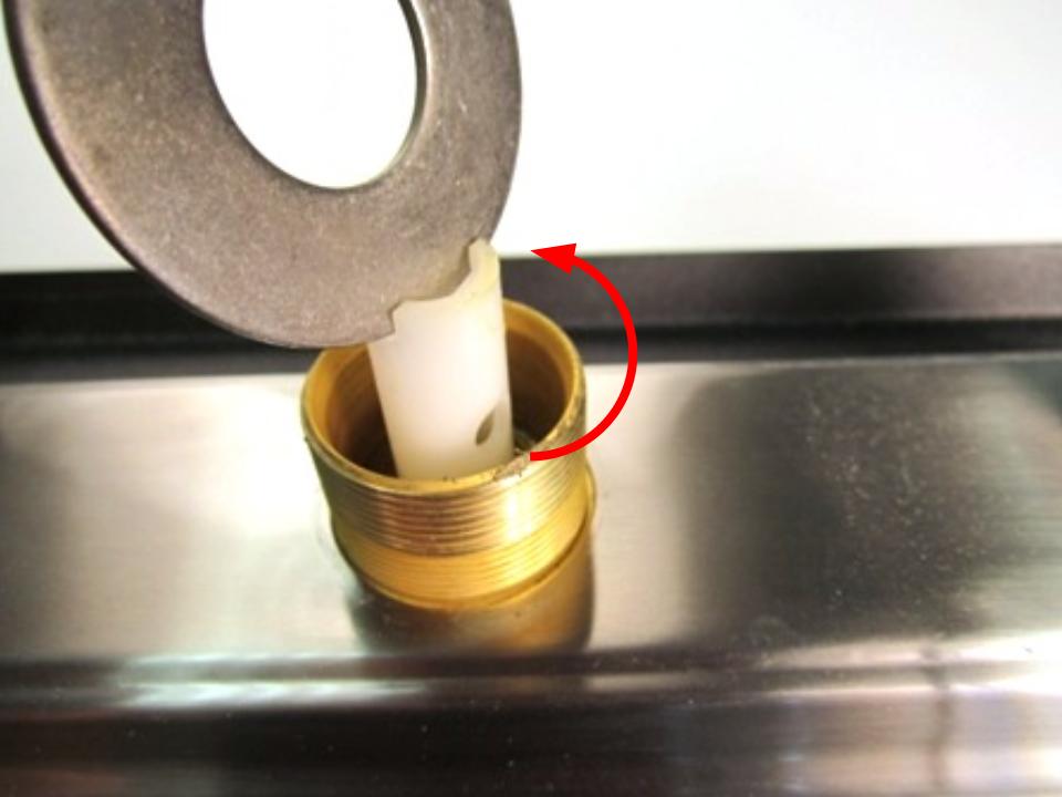 Once the spout has been removed, the top of the diverter should be visible. Locate the two openings and insert a flat tool or object. Turn counter clockwise until it is completely removed from the faucet body.