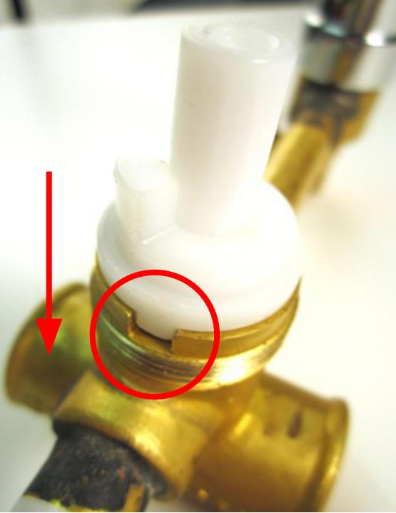 Slide the cartridge into the faucet body so that the notches on the cartridge line up with the grooves on the faucet body.
