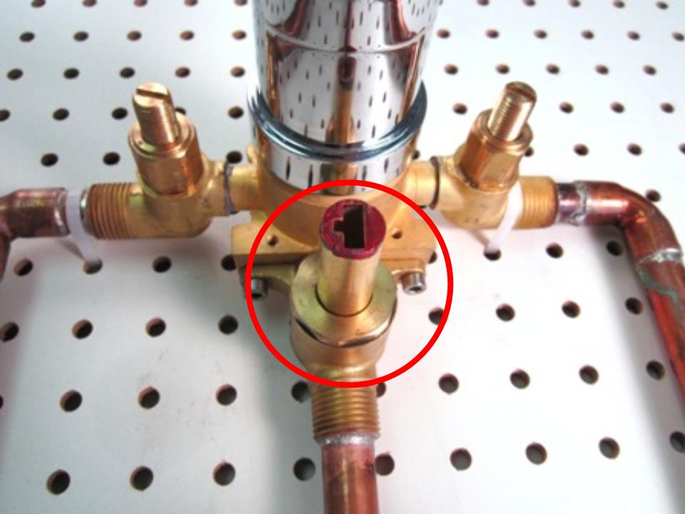 Once the faceplate has been removed, the main shower cartridge, as well as the diverter cartridge will be visible. 