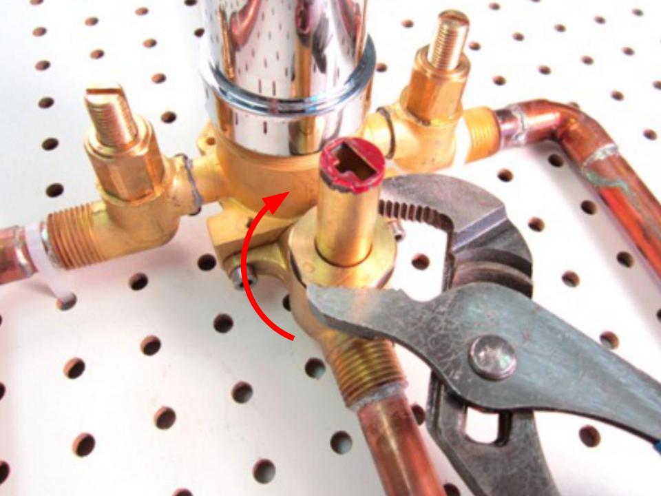  Install the rubber seal and plastic seat on top of the spring.