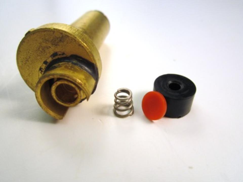From left to right:  (1) the diverter, (2) plastic seal, (3) rubber seat and (4) spring.