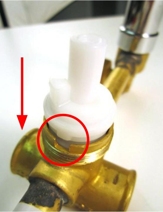 Slide the cartridge into the faucet body so that the notches on the cartridge line up with the grooves on the faucet body.