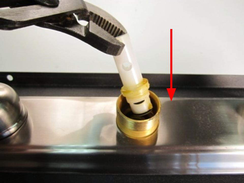 Slide the diverter into the faucet body. Using the tool you used to remove the diverter, screw the diverter into the faucet body by turning clockwise.