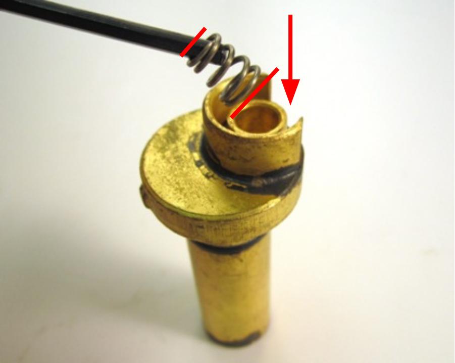  Install the rubber seal and plastic seat on top of the spring.