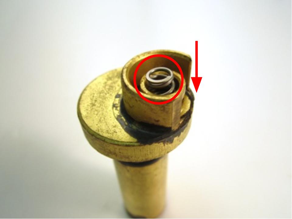  Install the rubber seal and plastic seat on top of the spring.