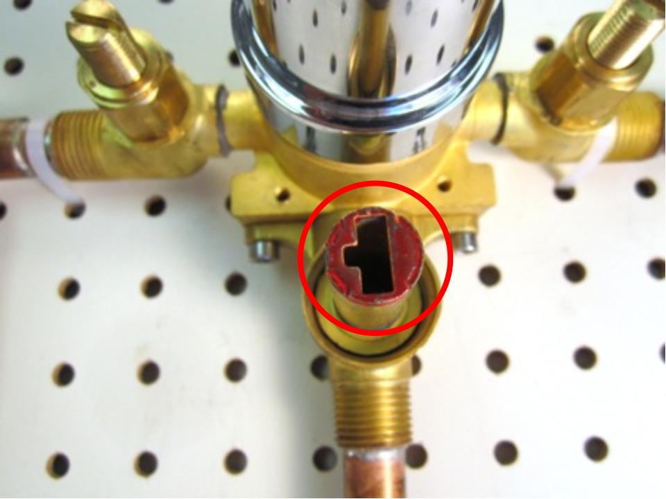  Install the rubber seal and plastic seat on top of the spring.