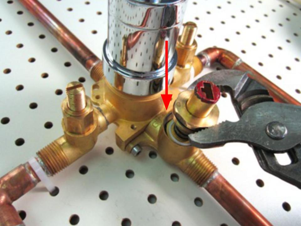  Install the rubber seal and plastic seat on top of the spring.
