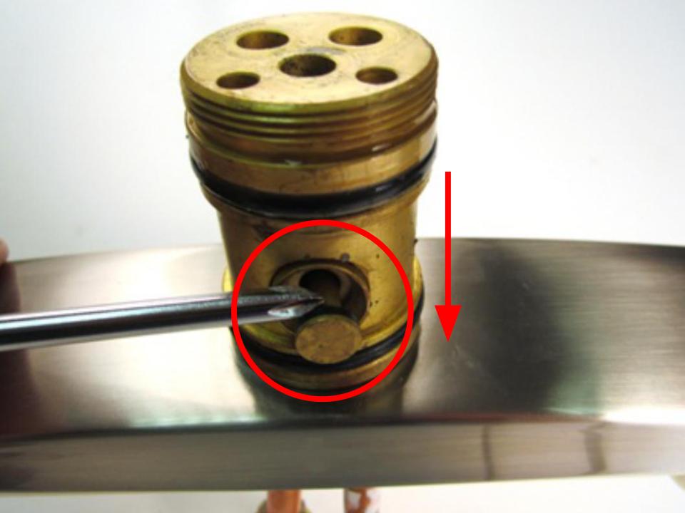 Once the spout is removed, the diverter will be visible. Use a tool with a thin flat edge to pry the diverter out of the faucet body.