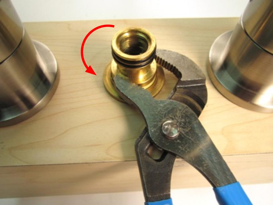 Once the spout has been removed, the spout adapter should be visible. To remove the spout adapter, use a pair of adjustable plyers. Using the plyers, turn counter-clockwise until the spout adapter is removed.