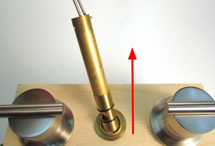 Make sure that both of the pins on the diverter removal tool slide into the corresponding holes. Pull up until the diverter is completely removed from the faucet body.
