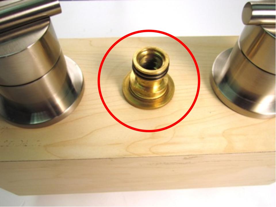Once the spout has been removed, the spout adapter should be visible. To remove the spout adapter, use a pair of adjustable plyers. Using the plyers, turn counter-clockwise until the spout adapter is removed.