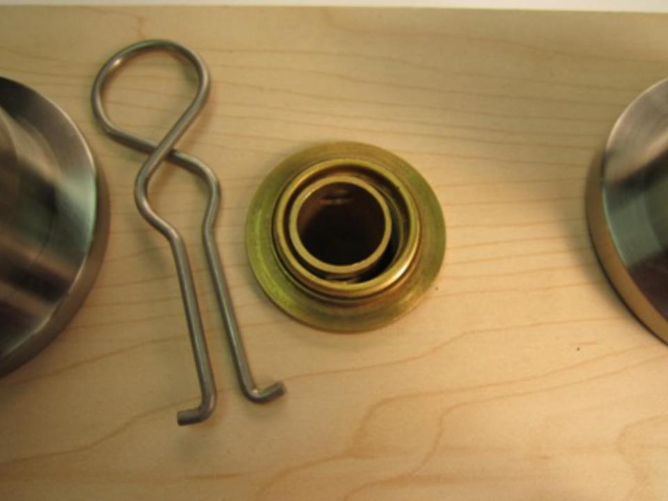  Once the spout adapter has been removed, the top of the diverter should be visible. Locate the two holes at the top of the diverter and insert the diverter removal tool into the two holes.