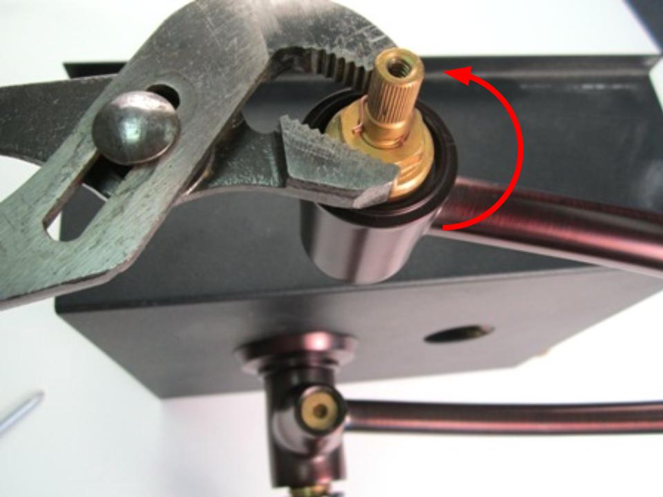 The cartridge is threaded into the faucet body. To remove the cartridge, use adjustable pliers to unscrew the cartridge counter-clockwise.