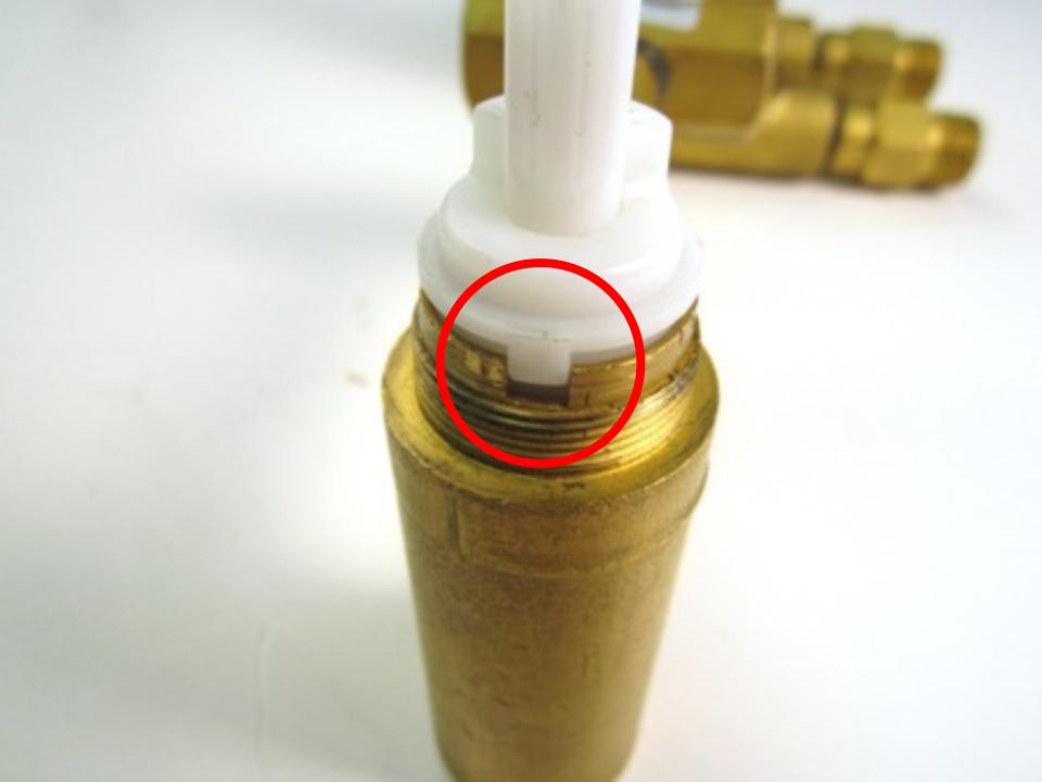 Insert the cartridge into the valve body.  When installing it into the valve, make sure the flat side of the D shaped stem is facing left.  The cartridge has 2 pieces of brass that stick out slightly on each side.  These fit into matching grooves in the faucet body.  Fit the cartridge in so the sides fit into these grooves.