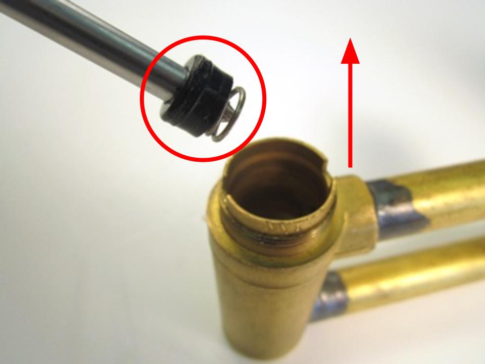 If you cannot remove the seat and spring with your fingers, use a pair of needle nose pliers or a straightened paper clip to remove them.