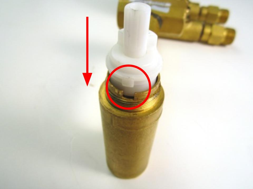 Insert the cartridge into the valve body.  When installing it into the valve, make sure the flat side of the D shaped stem is facing left.  The cartridge has 2 pieces of brass that stick out slightly on each side.  These fit into matching grooves in the faucet body.  Fit the cartridge in so the sides fit into these grooves.