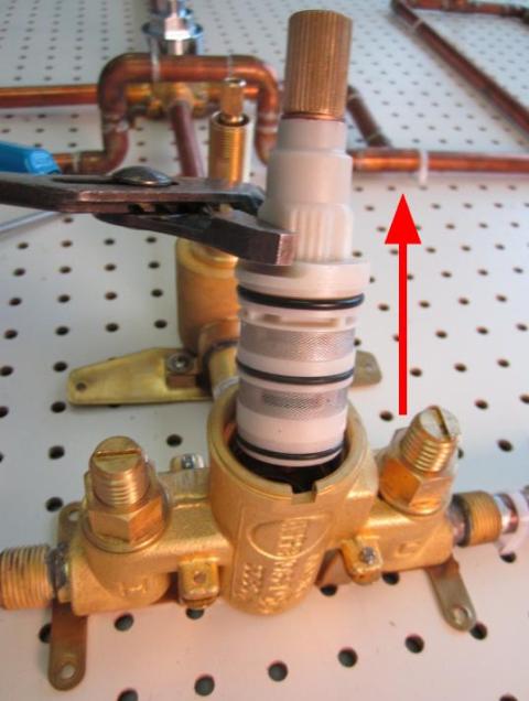 Hold the stem of the cartridge and pull out until the cartridge is completely removed from the faucet body