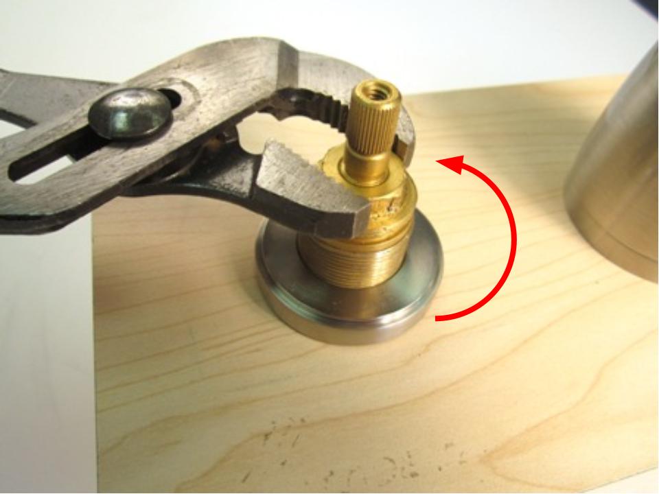 Using a pair of adjustable pliers, remove the brass locking nut.